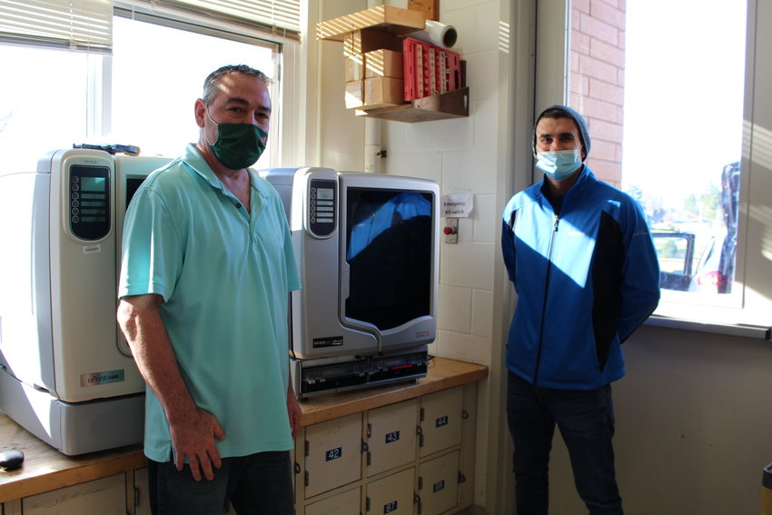 William Oefelein, left, and Richard Music pose with the newly donated 3D printer.